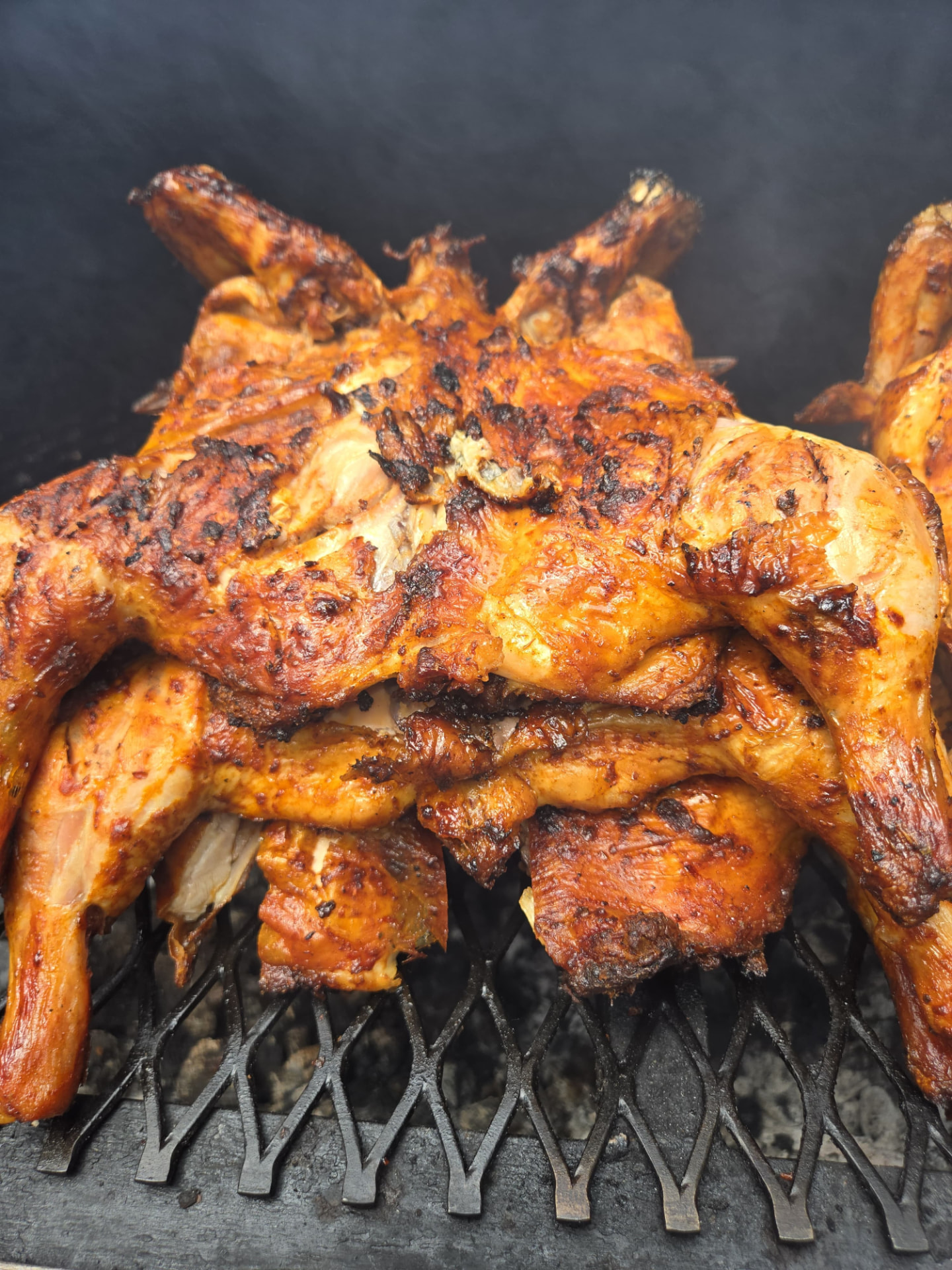 Chickens cooking over the charcoal grill